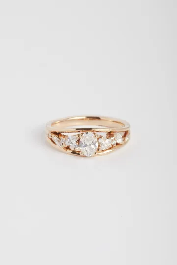 The Mylène ring, in 18k rose gold, set with an oval diamond and accompanied by marquise and brilliant diamonds.